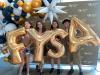 4 students hold up balloon letters of "FYSA"