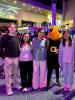 Four students pose with Georgia Tech mascot Buzz at the Georgia Aquarium.