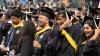 Students smiling and cheering at Commencement.