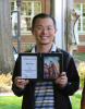 Photo of Molei Tao holding a College of Sciences Faculty Development Award during the 2022 Spring Sciences Celebration.