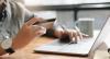 hands at laptop with credit card