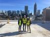 Infrastructure and Sustainability construction team members on the roof of the DM Smith building.