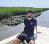 Tanner Lee (Georgia Tech, BS Biology '23) helped construct the oyster reef he observes from a boat as part of an undergraduate research project.