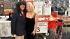 Two college students stand in front of a table with academic posters and a sign that reads "Georgia Tech Capstone Expo."