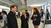   Ellen M. Bassett, John Portman Chair and Dean of the Georgia Tech College of Design, center, with Gabe McGuire and Jemma Siegel who are explaining the process behind their project “Alglowrithm” in the Mason lobby on April 23, 2025. Alison Lumpkin (not pictured) was also part of the project  team.