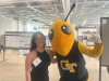 Young woman posting with Georgia Tech mascot Buzz.