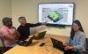 Pictured: Interactive PhD students Glen Smith (far left) and Qiao Zhang (far right) working with Assistant Professor Christopher MacLellan on the Dice Adventure game. 