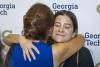 Two attendees of the 2025 Scholarship Brunch embrace.