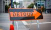 A detour sign on a street