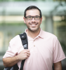 Man standing with book bag