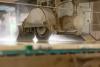 saw machine cutting fabricated stone under running water.