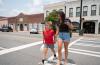 This image shows two people crossing one of the main streets of downtown Pembroke