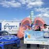 A blue race car, a sculpture of a lung, and students holding a sign