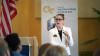 Dean Amanda Murdie speaks with an American flag and white Ivan Allen College of Liberal Arts banner in the background.