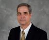 Portrait photo of Doug Williams, interim Dean of the College of Engineering. He is wearing a blue blazer, white shirt, and gold tie.