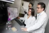 Three Georgia Tech researchers working together in the lab on cancer research