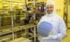 Asif Khan holds a silicon wafer in a cleanroom.