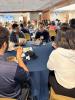 Students and an employer sit and talk at a round table.