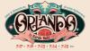 Promotional logo for the play Orlando by Sarah Ruhl, adapted from the novel by Virginia Woolf. The stylized title is set against a dark oval background with a pink masquerade mask at the top and a pink banner below.
