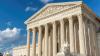 Outside of the U.S. Supreme Court Building on a sunny day.