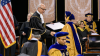 student receiving their diploma at a GT PhD commencement ceremony
