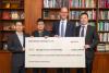 Speed Wireless presents check to ECE for $2.1 million.