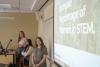 Students talk during a classroom presentation.