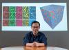 Georgia Tech professor Ting Zhu in front of colorful graphics