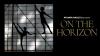 ATLANTA BALLET 2 ON THE HORIZON A male and female dancers are silhouetted against a backlit studio wall. The female is on the ground in arabesque en l'air and the man stands posed atop the barre in arabesque en terre.