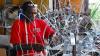 An artisan from Trinidad and Tobago uses traditional skills to build an intricate wire frame that will support a large, elaborate Carnival costume. 