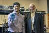 ECE professor Ali Adibi with Ph.D. candidate Sajjad Abdollahramezani holding their packaged tunable metasurface device.