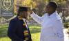 Adjusting a graduate's tassel before Fall 2020 Commencement
