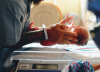 Image of newborn baby being weighed by a nurse