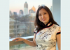 Jancy Ling Liu posing for a photo in front of the Atlanta skyline