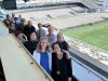 A group of people from the School of Public Policy standing on the upper part of bleachers, overlooking Grant Field.