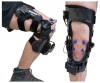 Instrumented knee brace that uses miniature microphones and accelerometers to study disease.