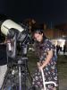 woman looking through telescope 