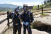 Emily Kaufman and Darshan Chudasama in protective gear at the entrance of the cave