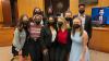 The Mock Trial B Team poses together in masks after a competition at the Fulton County Courthouse.