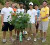 students standing aside a tree they recently planted