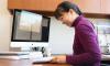 Iris Tien looks at documents at her desk