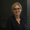 headshot of Laura Taylor in front of a black chalkboard