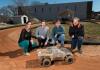 Researchers with autonomous racing vehicle