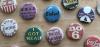 A selection of queer-themed buttons on a table.