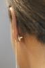 Contraceptive earring on a woman's ear - vertical format