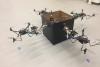 Four drones attached to a package