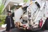 pic of emma brodzik in master's garb and recycling truck