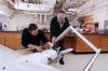 Mike Heiges (right) adjusts GTRI’s Airborne Unmanned Sensor System (GAUSS)