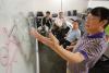 Professor at White Board With Students