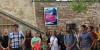 Students in front of old wall with German ad on it